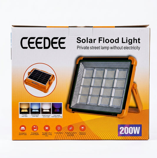 A boxed CEEDEE 200W solar flood light displayed on a store shelf next to other electronics.